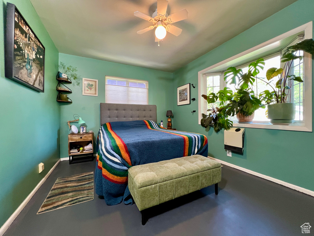 Bedroom featuring concrete flooring and ceiling fan