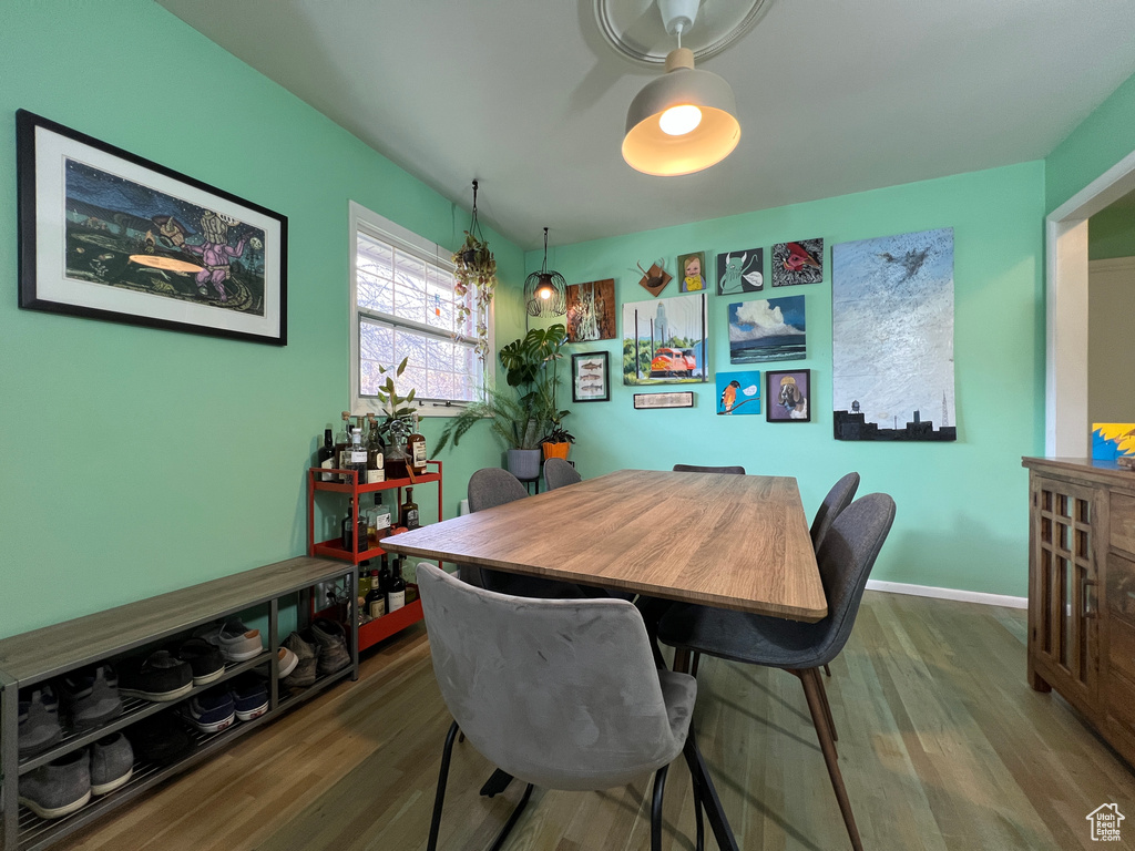 Dining area with dark hardwood / wood-style flooring