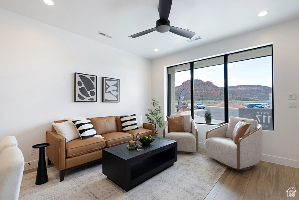 Living room featuring light wood-type flooring and ceiling fan