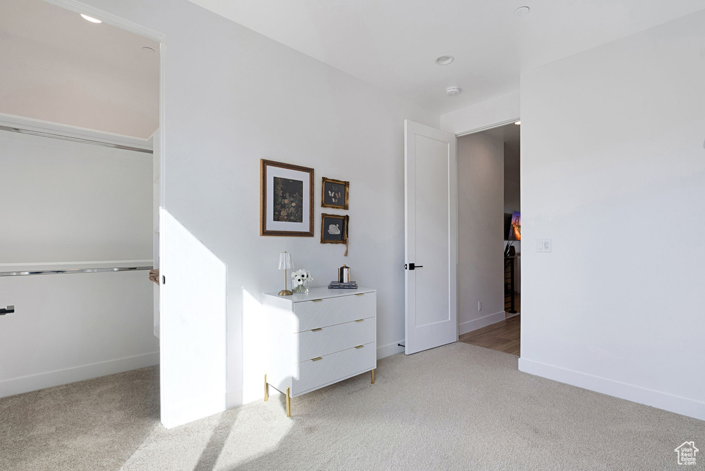 Unfurnished bedroom featuring light carpet