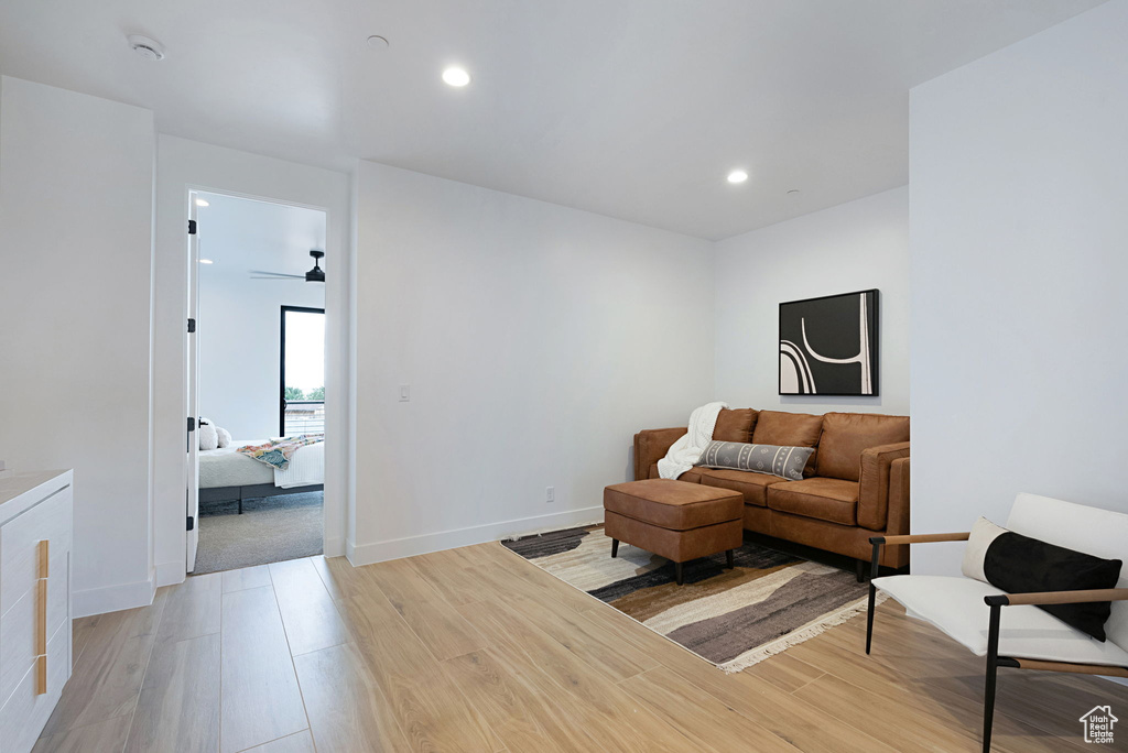 Living room with light wood-type flooring and ceiling fan