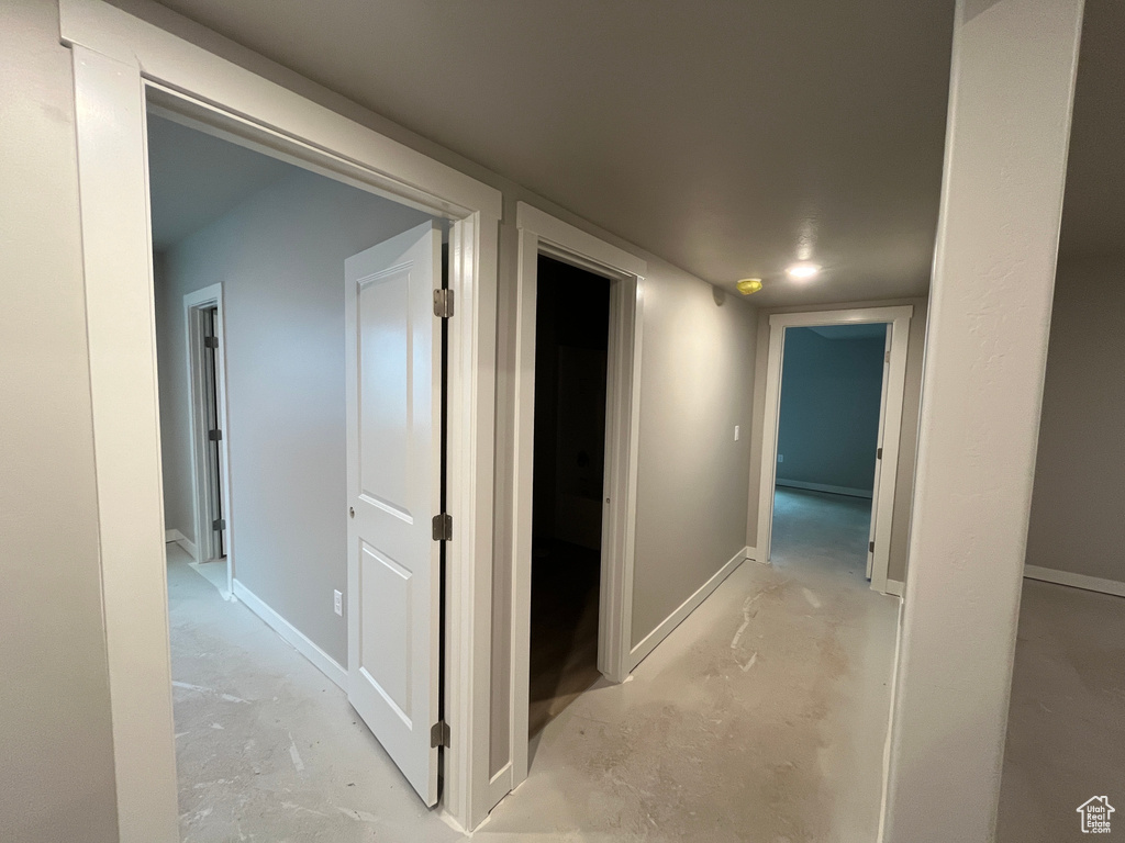 Hallway featuring concrete floors