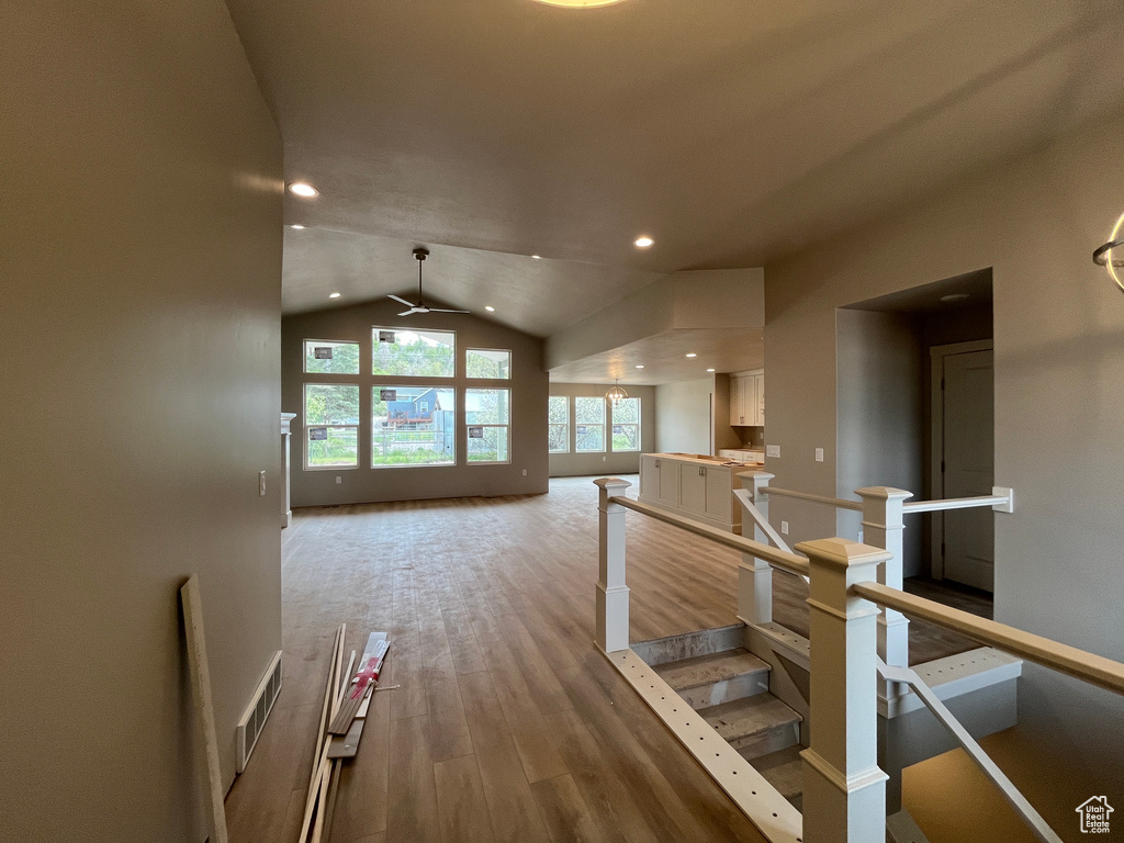 Hall featuring vaulted ceiling and hardwood / wood-style flooring