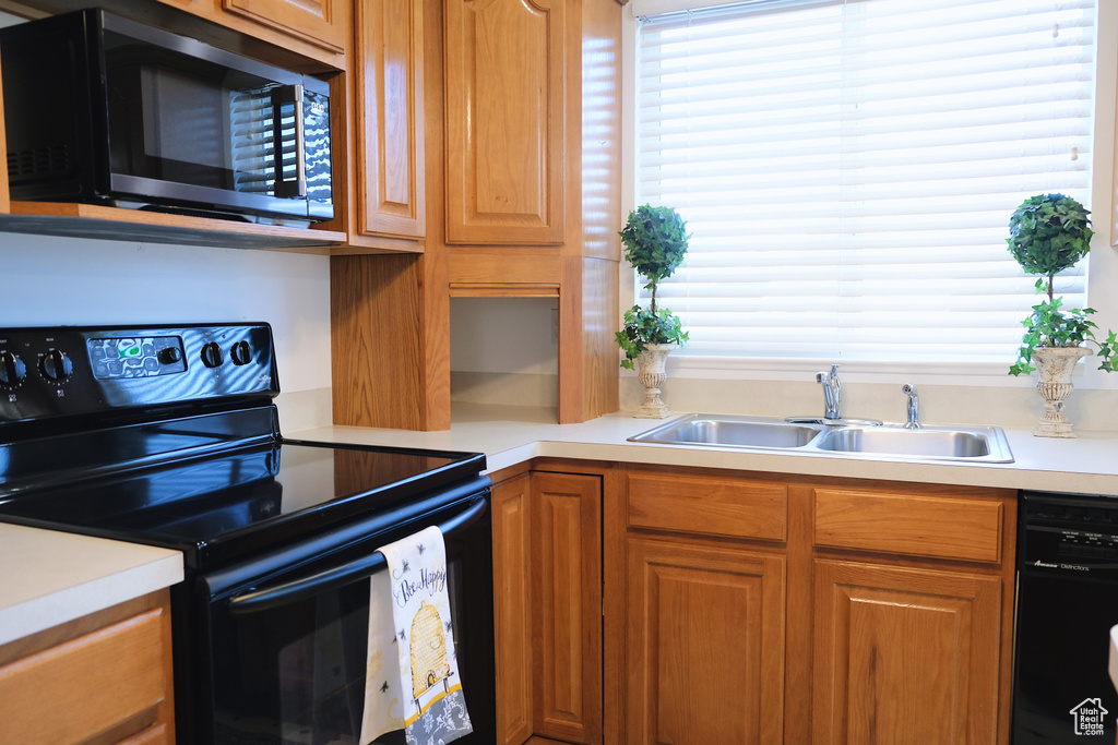 Kitchen with black appliances and sink