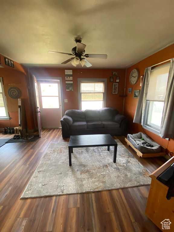 Living room featuring dark hardwood / wood-style flooring, plenty of natural light, and ceiling fan