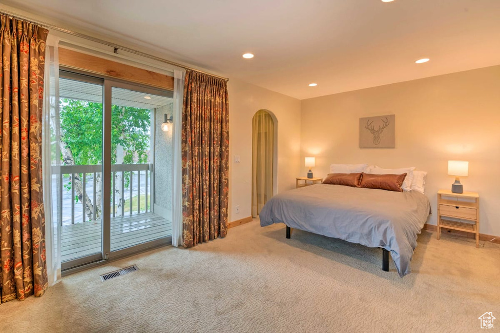 Carpeted bedroom featuring access to exterior and multiple windows