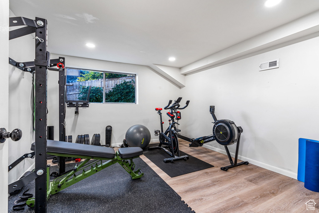 Workout area with hardwood / wood-style floors