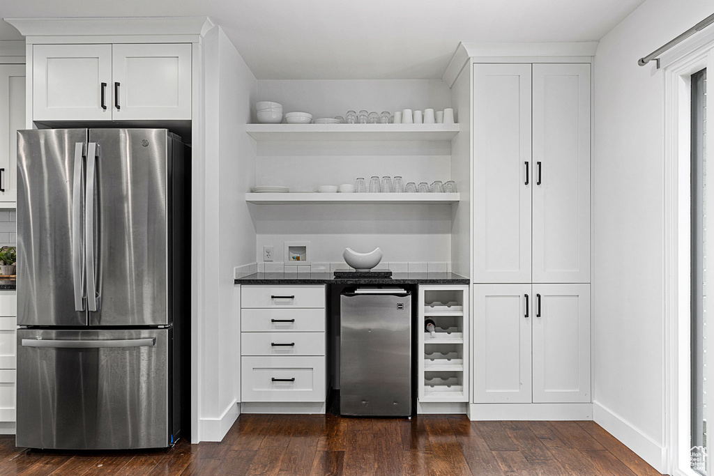 Kitchen featuring dark wood-type flooring, stainless steel fridge, and fridge