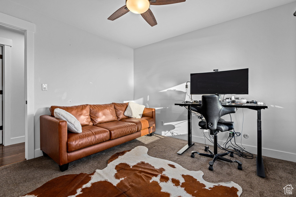 Office featuring ceiling fan and dark carpet
