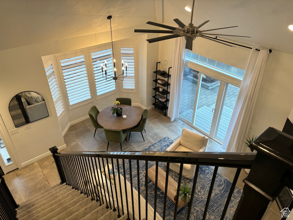 Stairway featuring tile flooring, vaulted ceiling, and ceiling fan