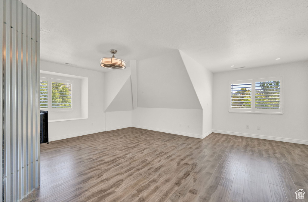 Unfurnished room with hardwood / wood-style flooring and a healthy amount of sunlight