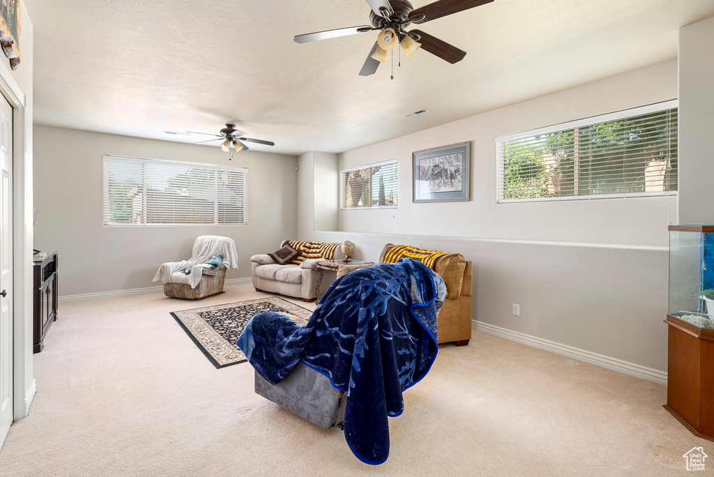 Living room with ceiling fan and carpet flooring