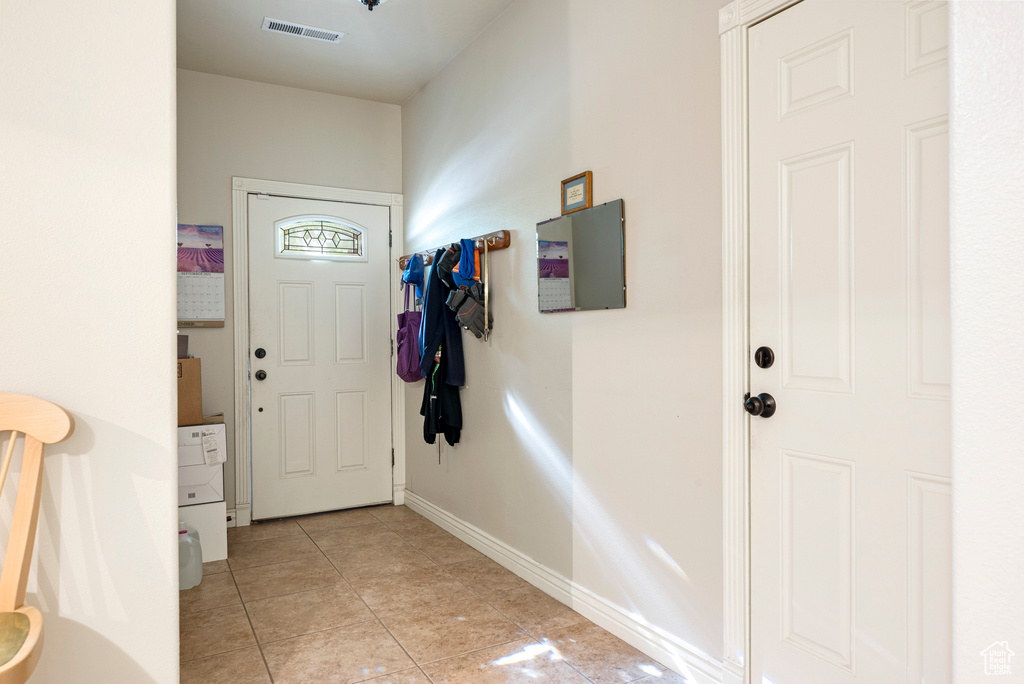 Entryway with light tile floors