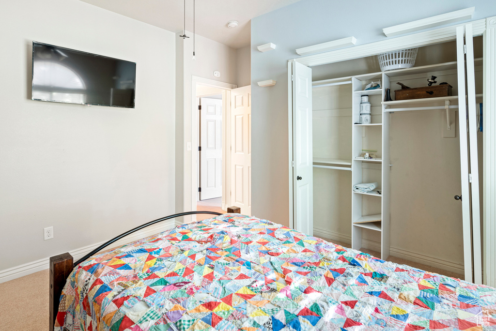 Bedroom featuring a closet and carpet flooring