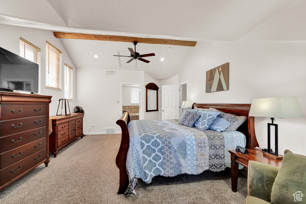 Carpeted bedroom featuring ceiling fan and vaulted ceiling with beams
