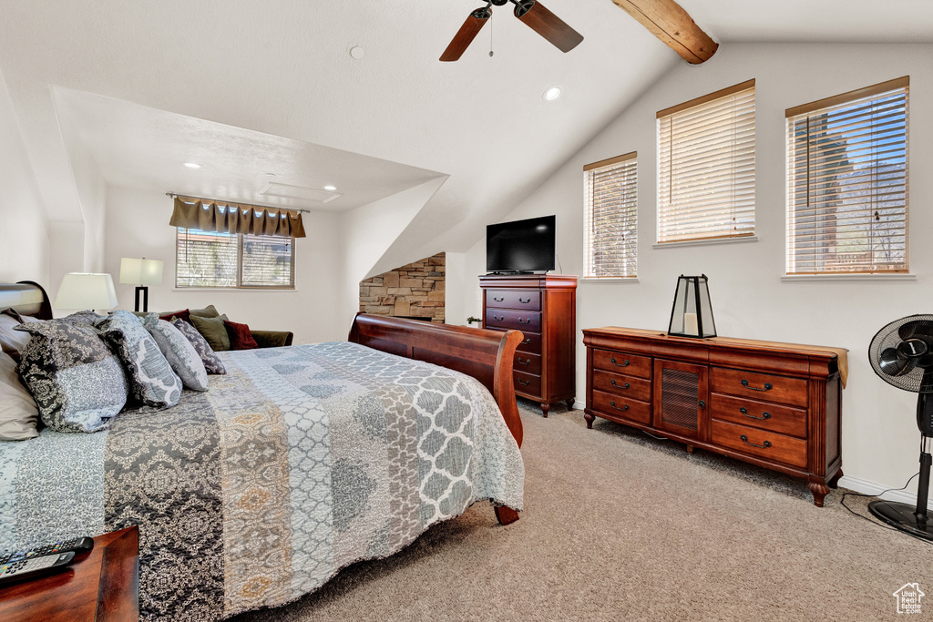 Carpeted bedroom with vaulted ceiling with beams and ceiling fan