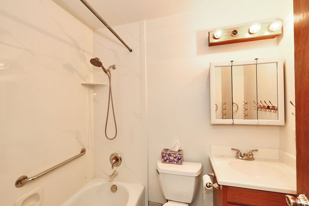 Full bathroom featuring shower / bathtub combination, vanity, and toilet