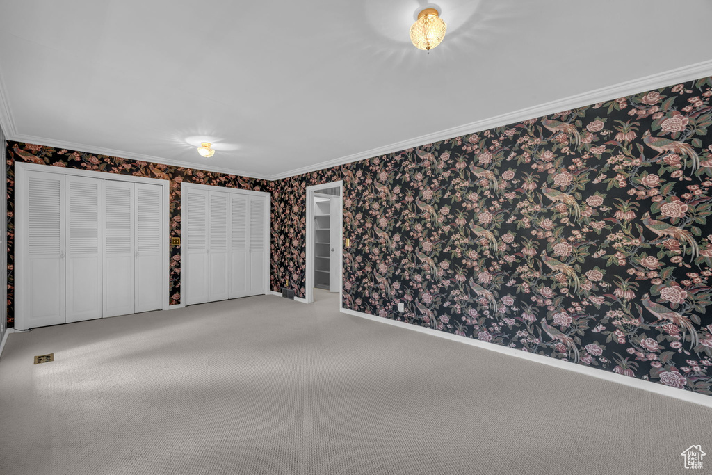 Carpeted spare room with ornamental molding