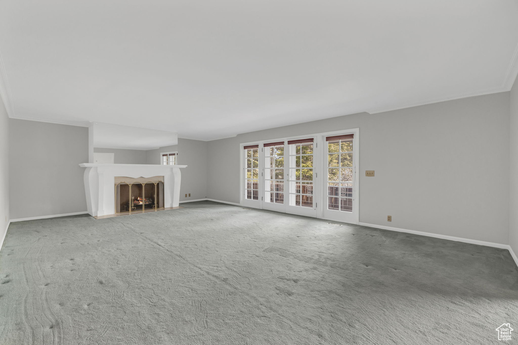 Unfurnished living room featuring carpet flooring