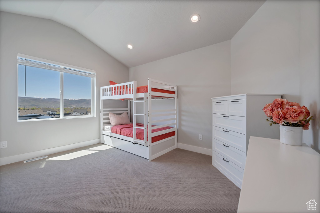 Unfurnished bedroom featuring lofted ceiling and carpet flooring