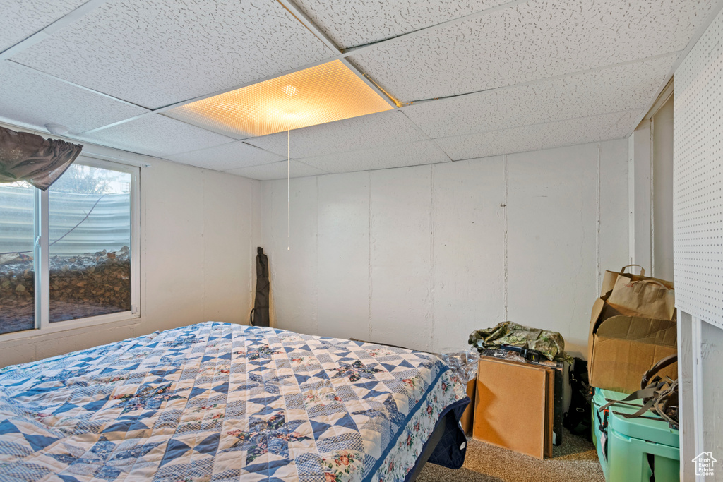 Carpeted bedroom with a drop ceiling