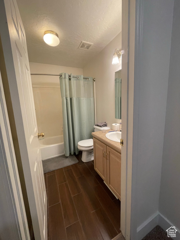 Full bathroom with shower / bath combo, toilet, and vanity