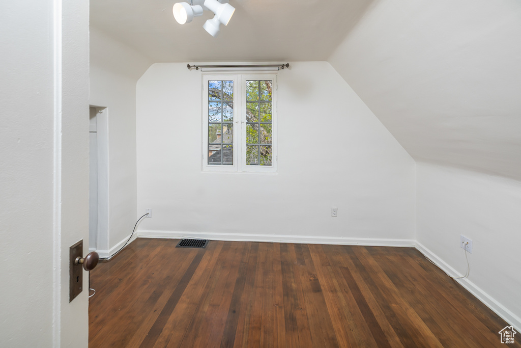 Bonus room with hardwood / wood-style flooring and lofted ceiling