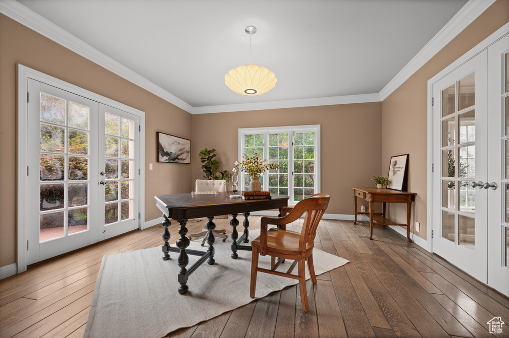 Office area featuring french doors, crown molding, and hardwood / wood-style flooring
