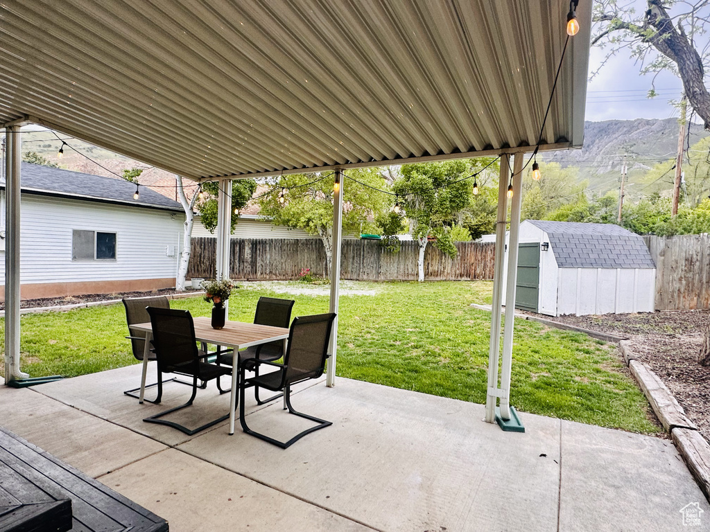 View of patio featuring a mountain view and a shed