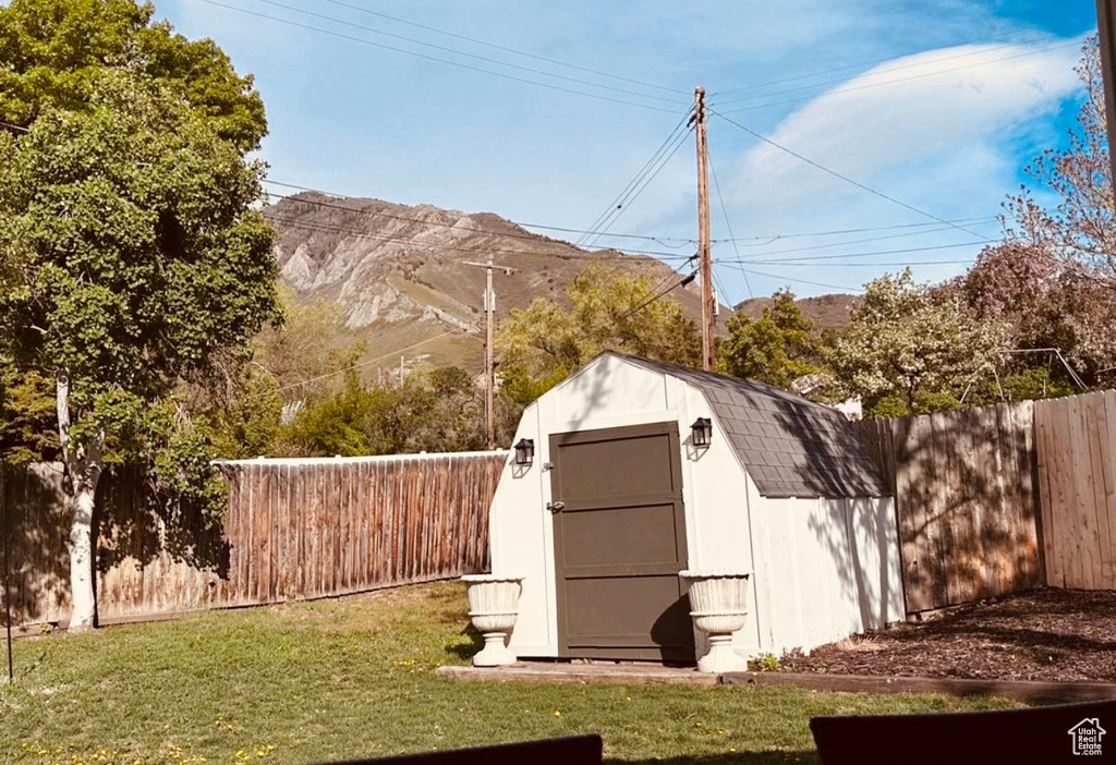 View of outdoor structure featuring a mountain view and a yard