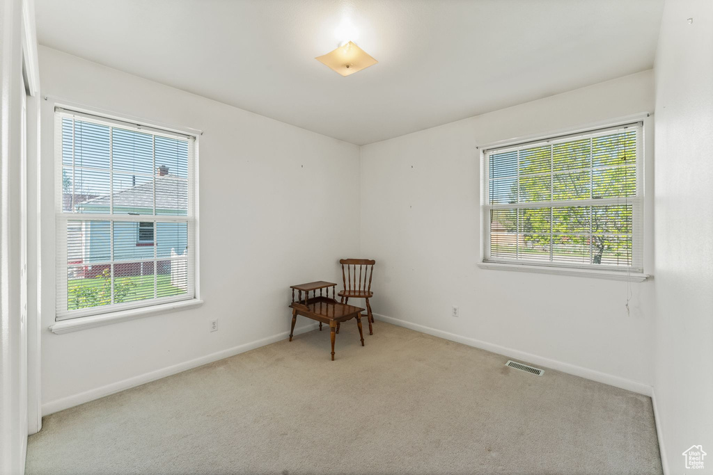 Spare room with a healthy amount of sunlight and carpet floors