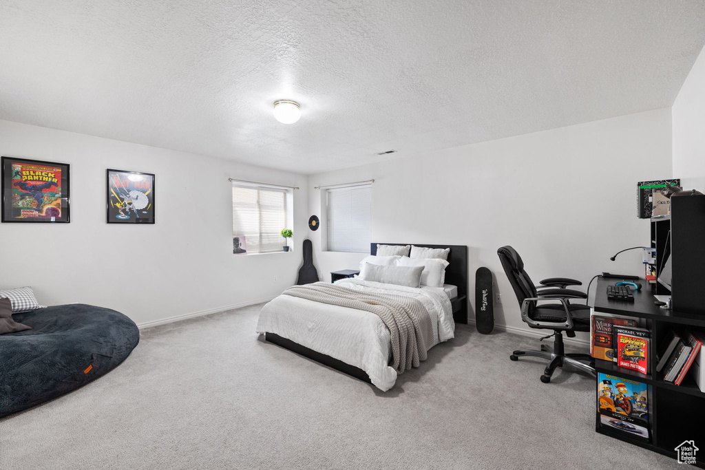 Bedroom featuring a textured ceiling and carpet flooring
