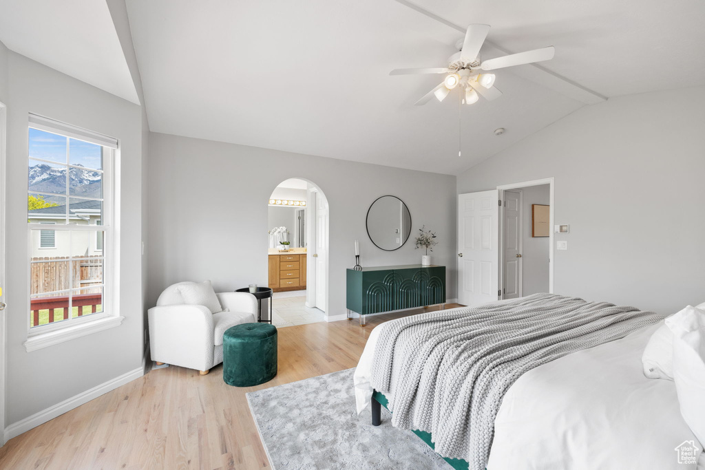 Bedroom featuring lofted ceiling, ceiling fan, light hardwood / wood-style floors, and multiple windows