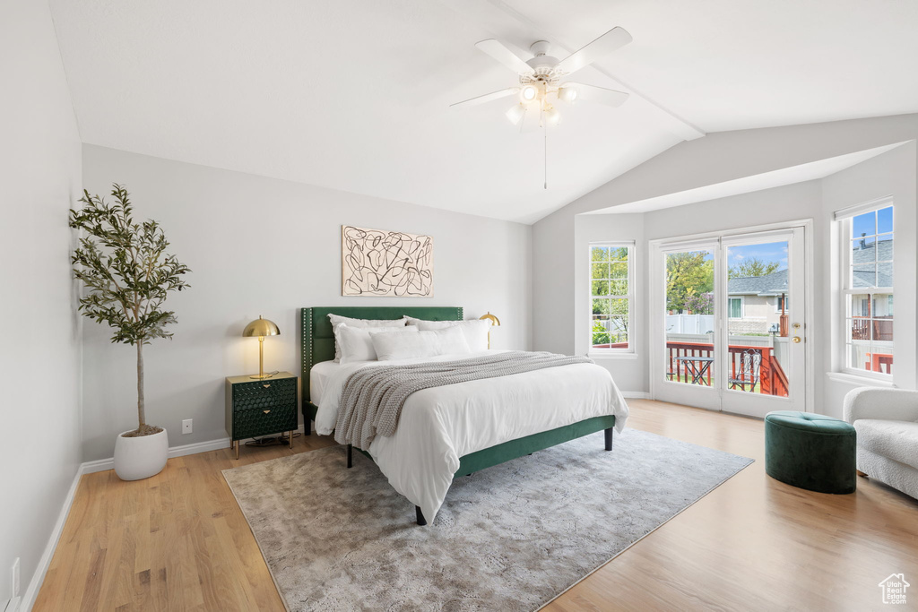 Bedroom featuring vaulted ceiling, ceiling fan, light wood-type flooring, and access to exterior