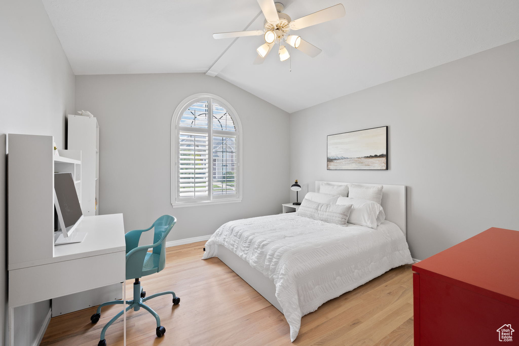 Bedroom featuring lofted ceiling, ceiling fan, and light wood-type flooring