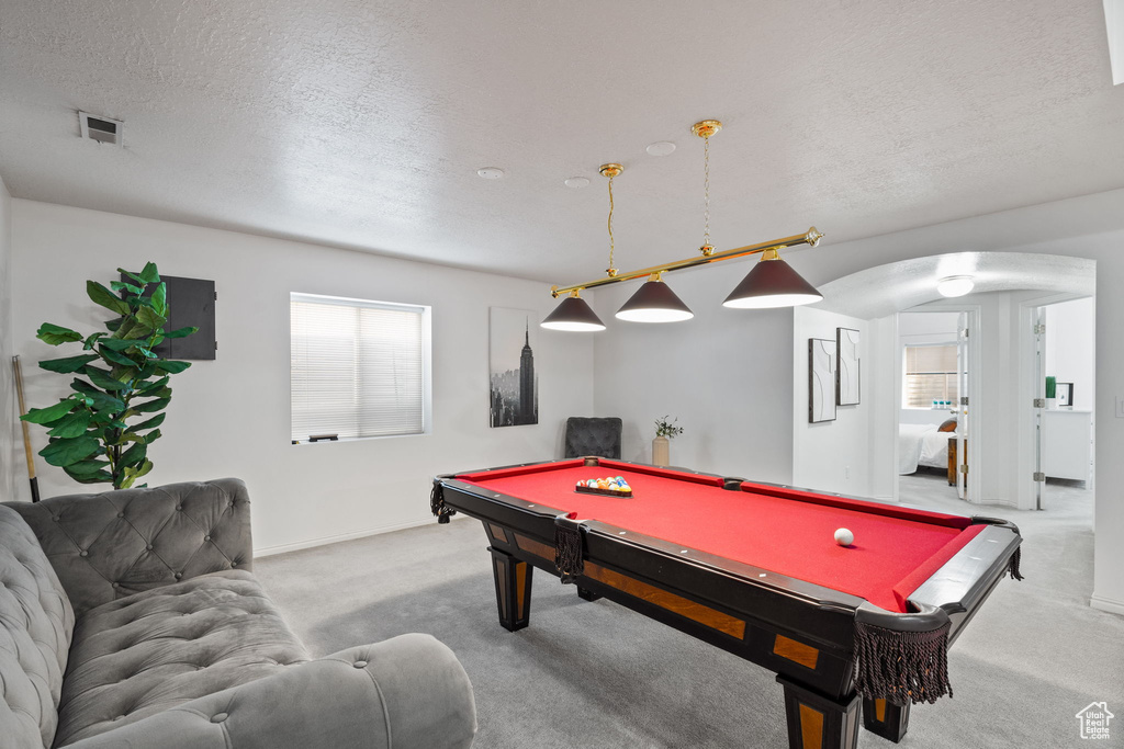Playroom featuring a textured ceiling, billiards, and carpet flooring