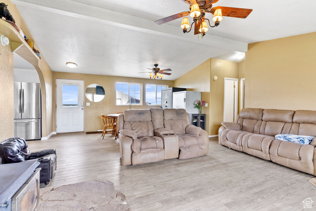 Living room with hardwood / wood-style flooring and ceiling fan