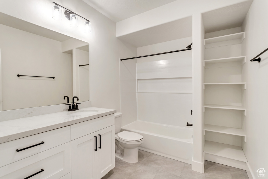 Full bathroom featuring tile flooring, shower / bath combination, vanity, and toilet