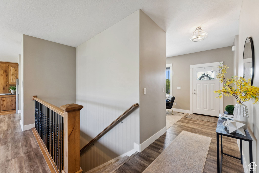 Foyer entrance with wood-type flooring