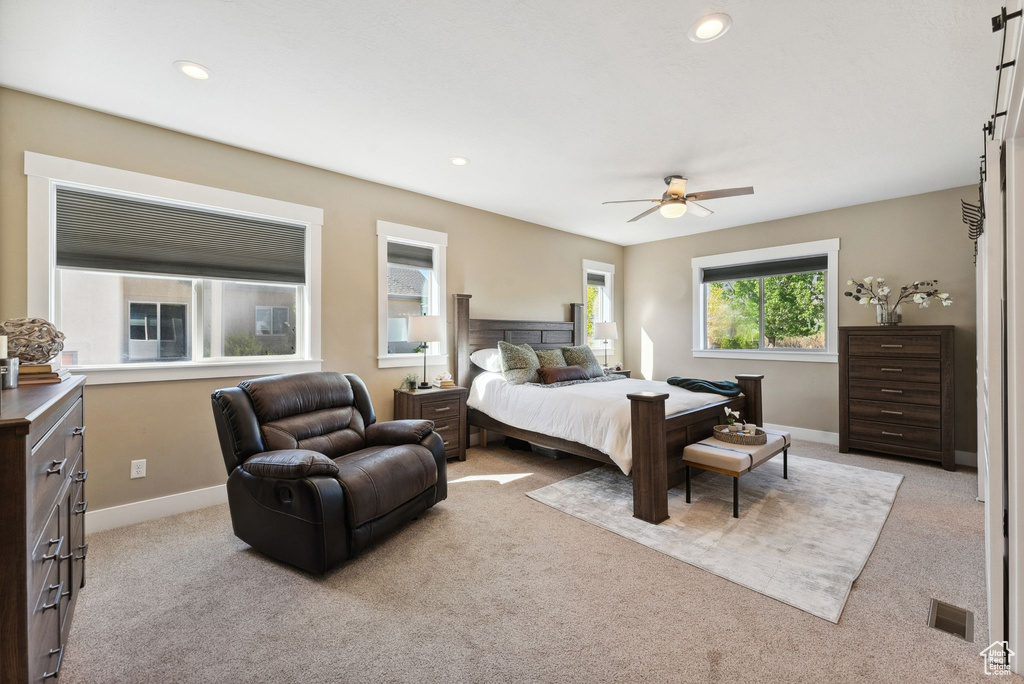 Carpeted bedroom featuring ceiling fan