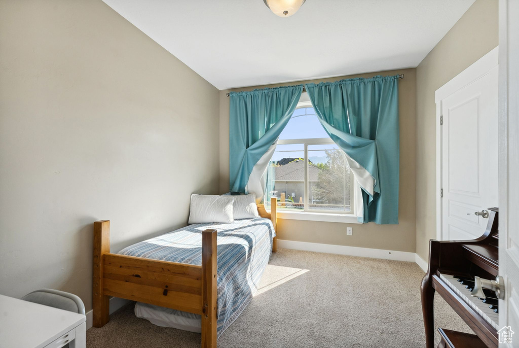 Bedroom with vaulted ceiling and carpet