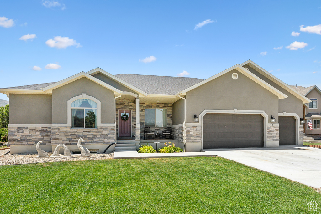 View of front of home featuring a garage and a front lawn