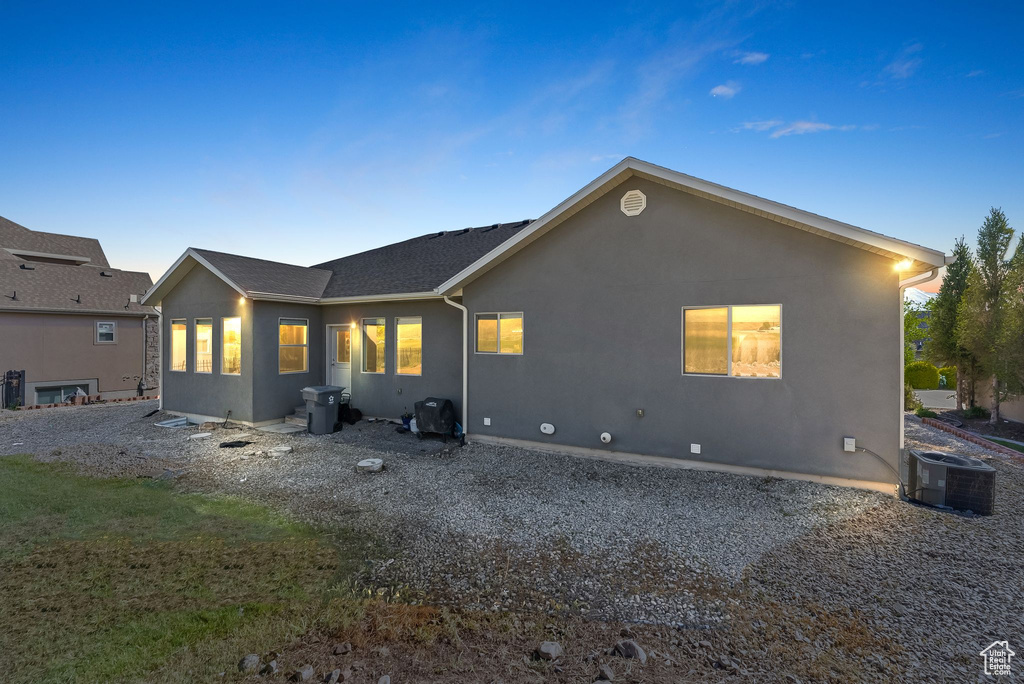 Rear view of property with central AC