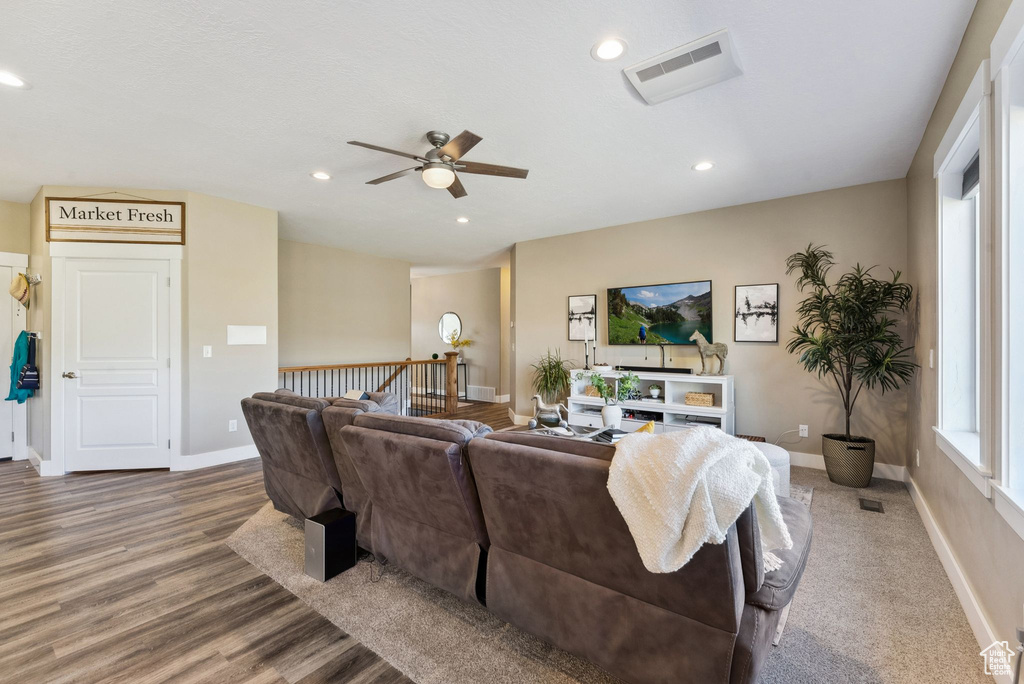 Living room with wood-type flooring and ceiling fan