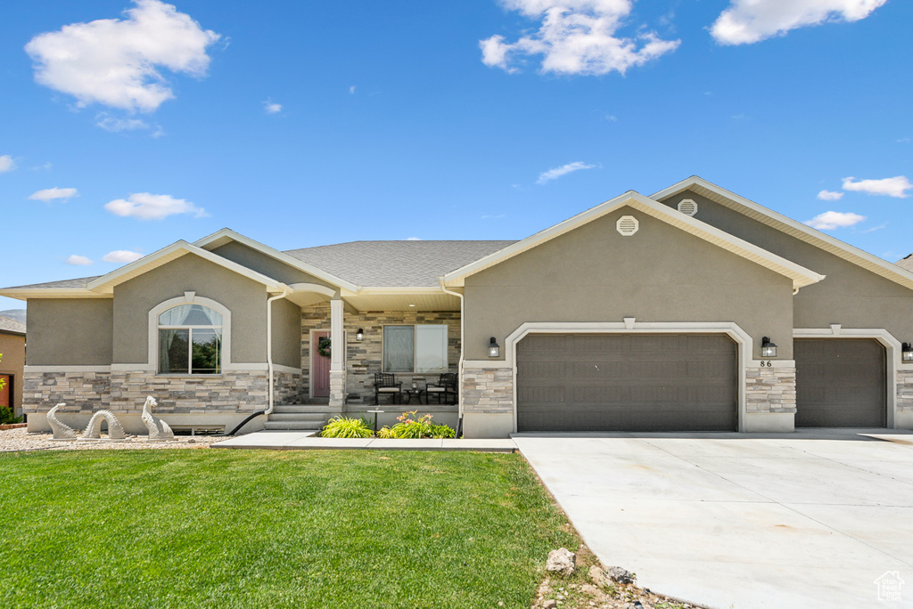 View of front of home featuring a front lawn and a garage