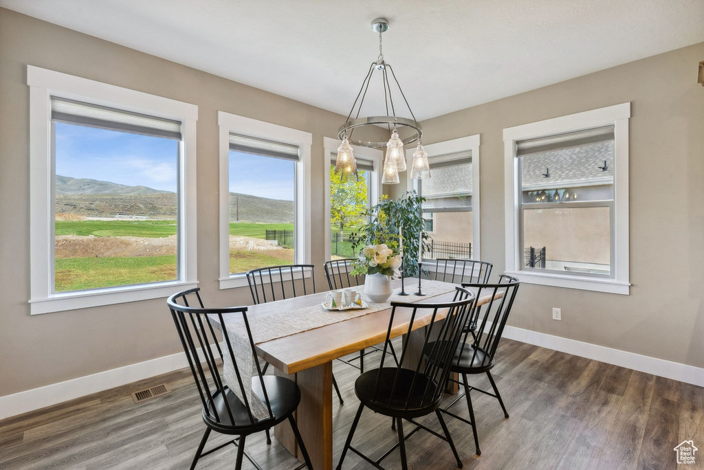 Dining room featuring an inviting chandelier, dark hardwood / wood-style flooring, and a mountain view