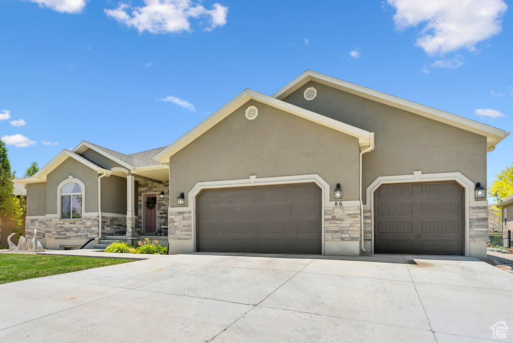 View of front facade featuring a garage