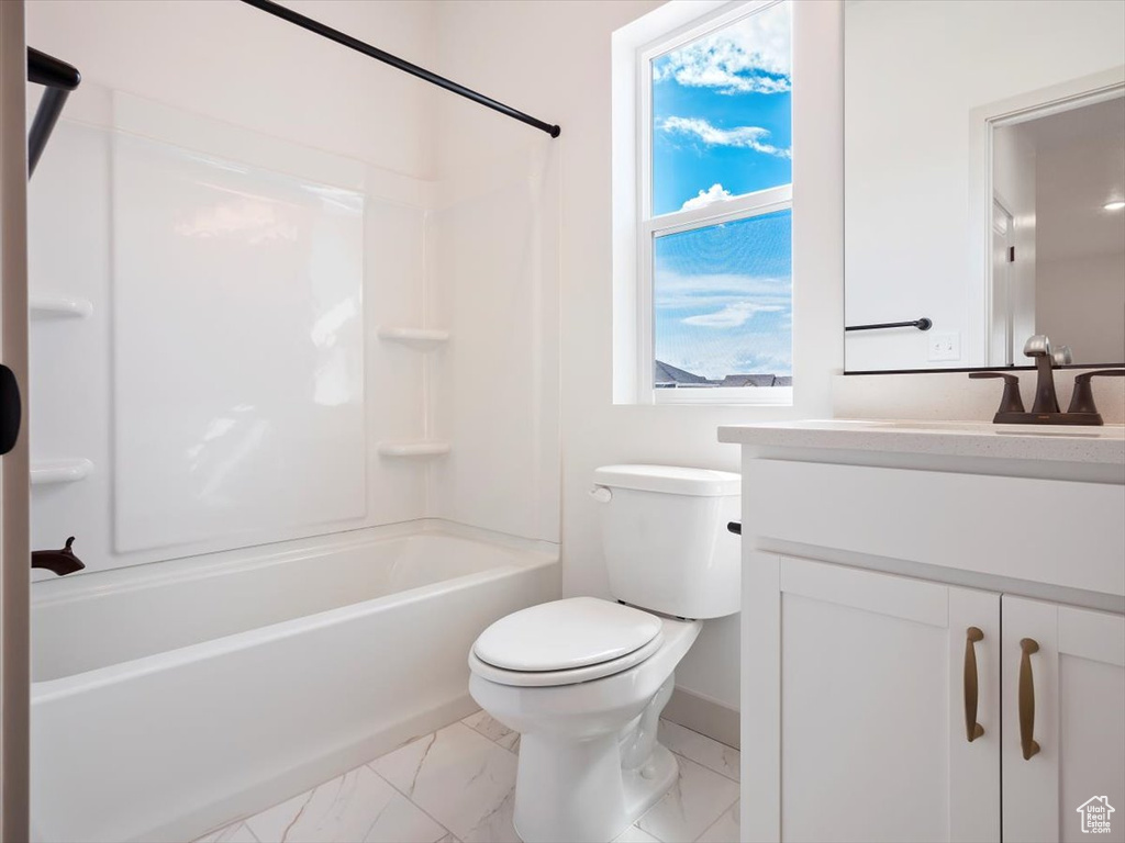 Full bathroom featuring plenty of natural light, toilet, bathtub / shower combination, and vanity