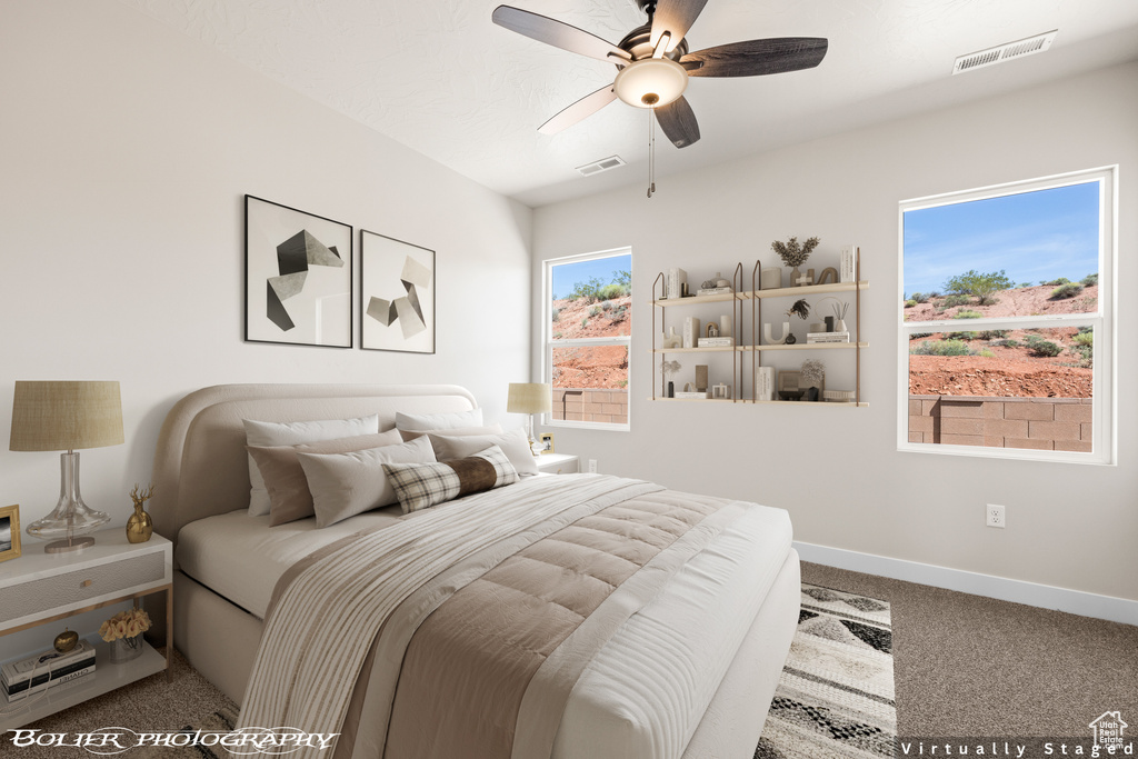 Bedroom featuring multiple windows, carpet, and ceiling fan