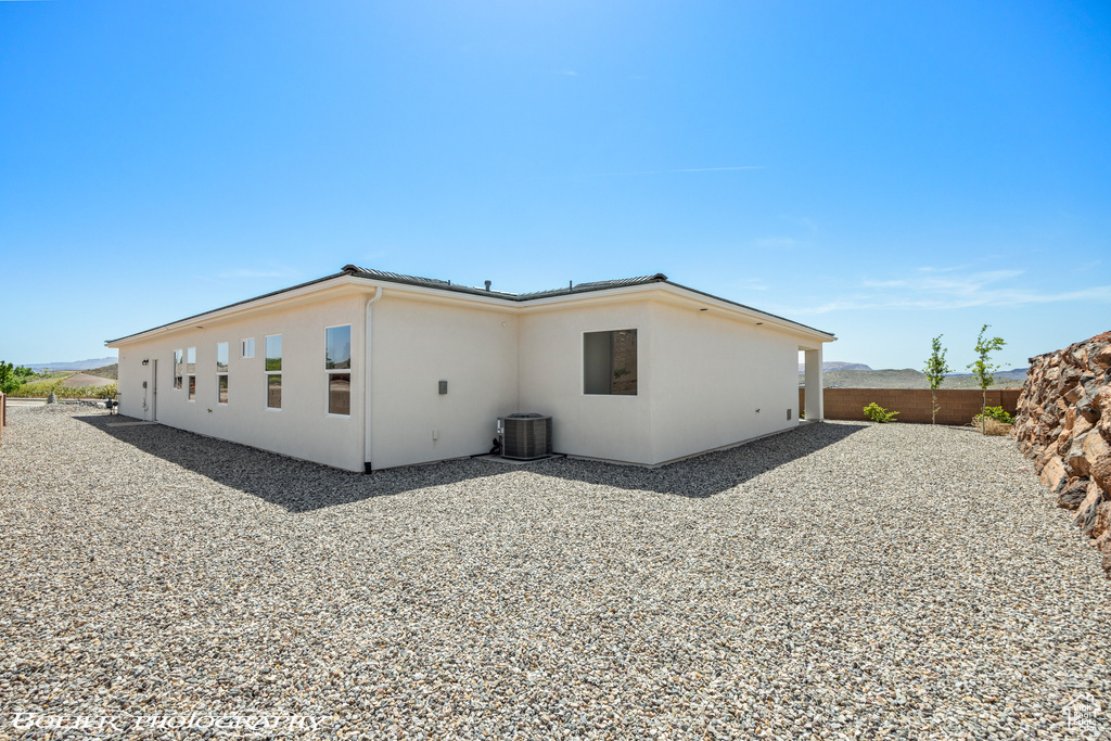 Rear view of house with a patio area and central air condition unit